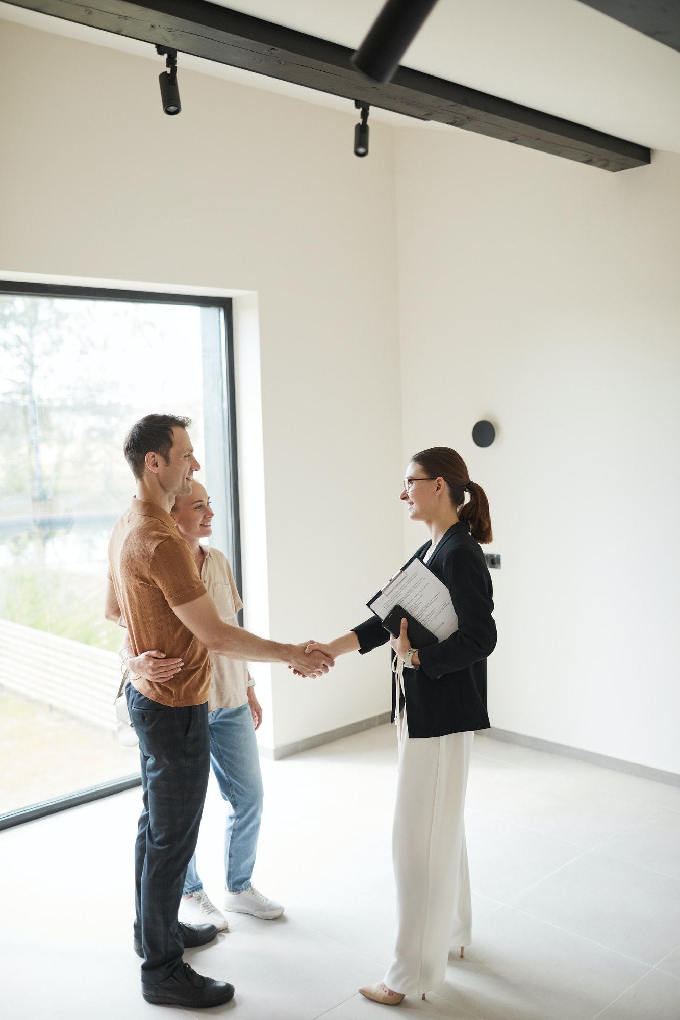 Couple Shaking Hands with Real Estate Agent